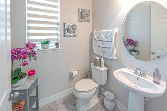 bathroom with tile patterned flooring, toilet, and sink