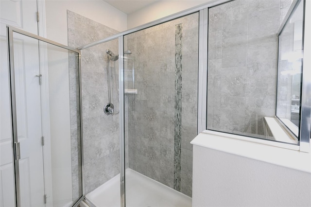 bathroom with a shower with door