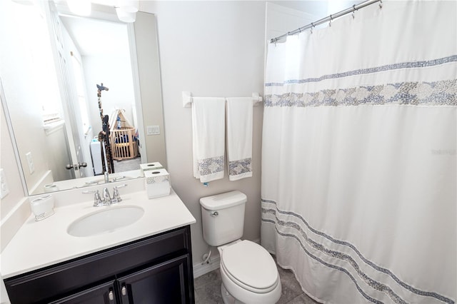 bathroom featuring tile patterned flooring, vanity, and toilet