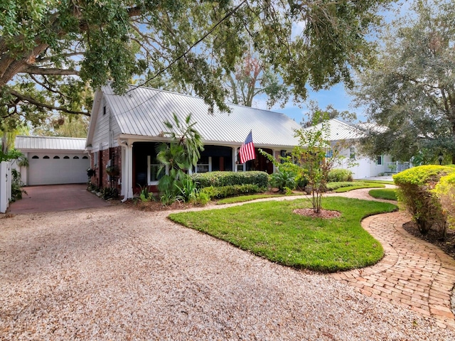 single story home with a front yard and a garage