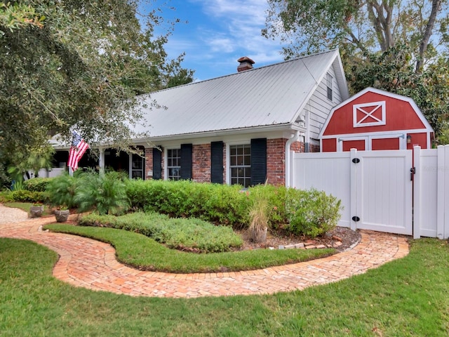 view of side of property with a yard and an outdoor structure