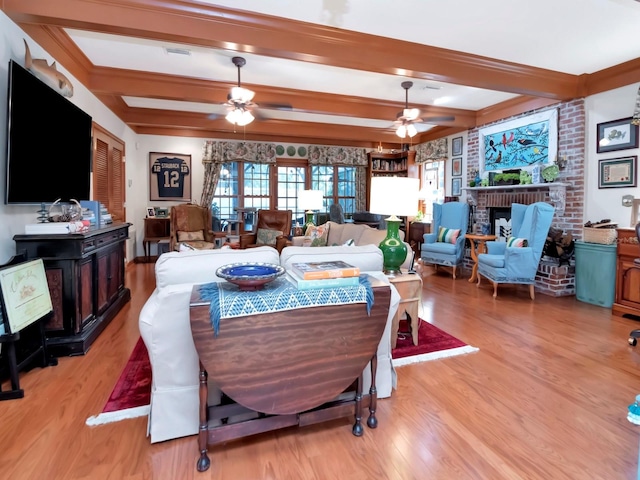 dining space featuring ceiling fan, beamed ceiling, and light wood-type flooring