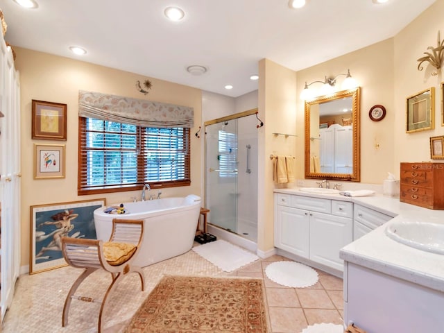 bathroom featuring tile patterned flooring, vanity, and separate shower and tub