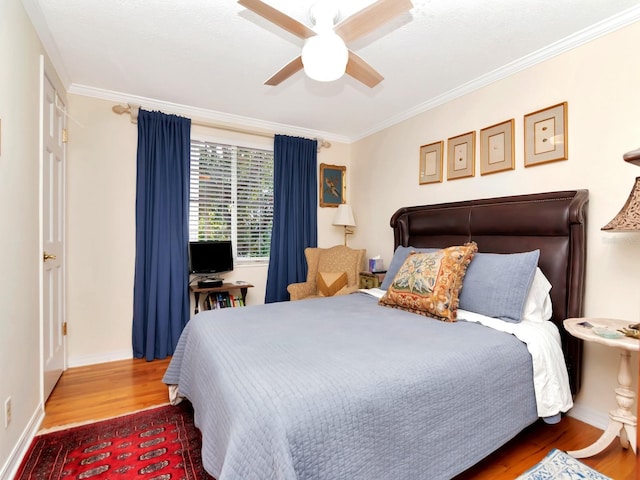 bedroom featuring hardwood / wood-style floors, ceiling fan, and ornamental molding