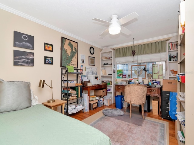 bedroom featuring ceiling fan, wood-type flooring, and ornamental molding