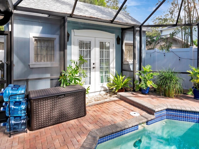 view of pool with a patio area, a lanai, and french doors