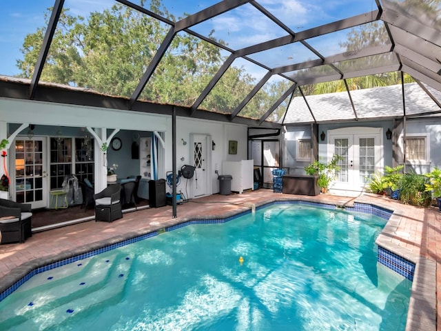 view of swimming pool with french doors, a patio, and a lanai