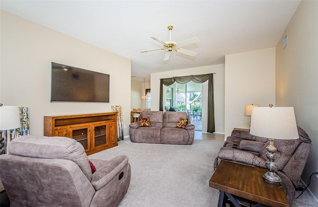 carpeted living room featuring ceiling fan