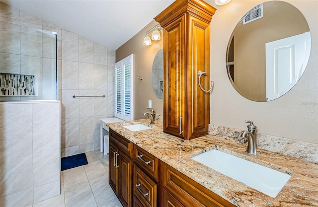 bathroom featuring tile patterned flooring, vanity, tile walls, and lofted ceiling