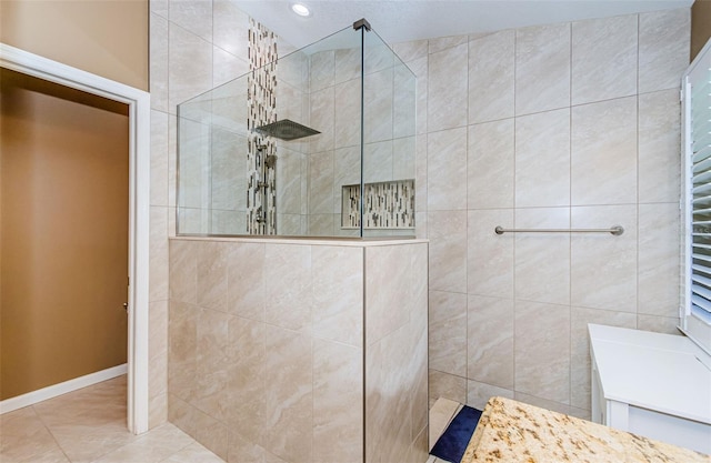 bathroom featuring tile patterned floors and tiled shower