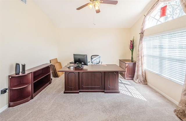 carpeted office space with vaulted ceiling and ceiling fan