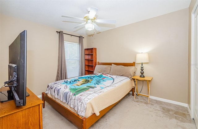 bedroom with ceiling fan and light carpet