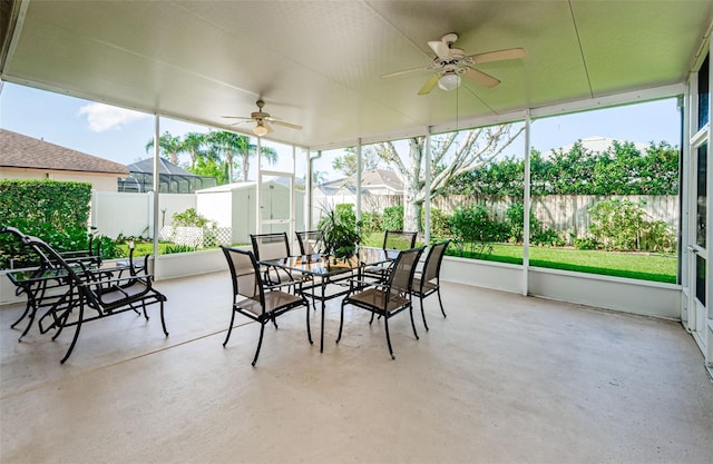 sunroom / solarium featuring ceiling fan