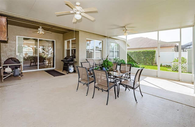 sunroom / solarium featuring ceiling fan