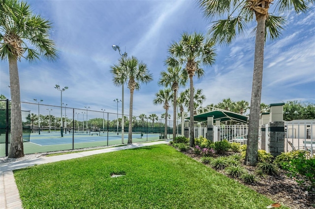 surrounding community featuring a lawn and tennis court