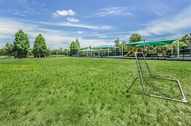 surrounding community featuring a playground and a yard