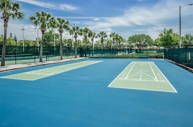 view of community with tennis court