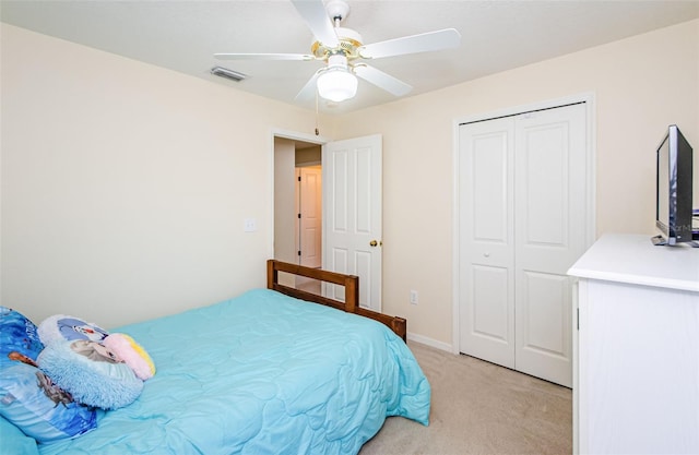 bedroom with light carpet, a closet, and ceiling fan