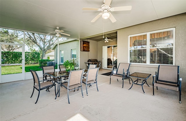 sunroom / solarium featuring ceiling fan