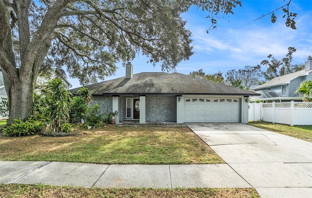 ranch-style home featuring a front yard and a garage