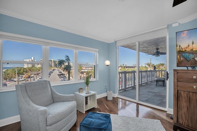 sitting room featuring hardwood / wood-style floors, ceiling fan, and crown molding