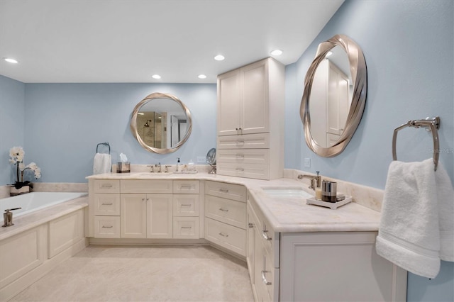 bathroom featuring a washtub and vanity