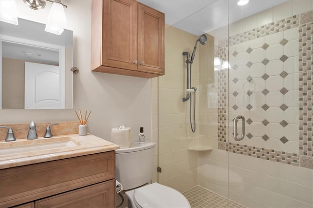 bathroom with toilet, vanity, and walk in shower