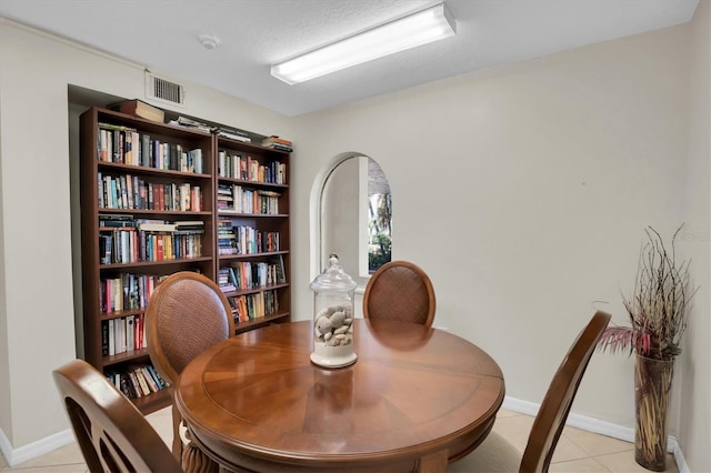 dining room with light tile patterned floors and a textured ceiling