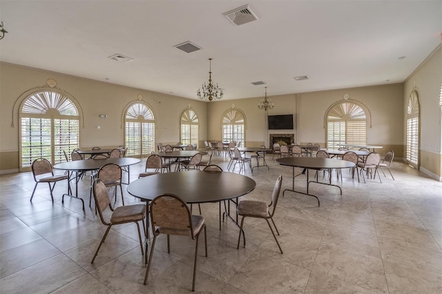 dining area featuring a healthy amount of sunlight and a notable chandelier