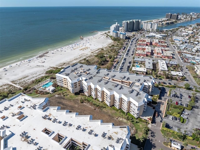 drone / aerial view with a water view and a beach view