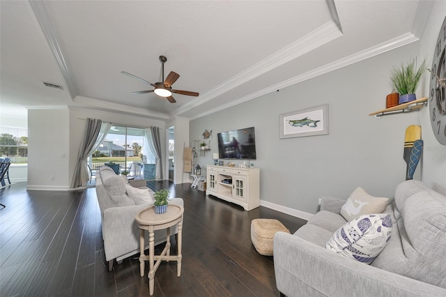 living room featuring crown molding, dark wood-type flooring, and a wealth of natural light