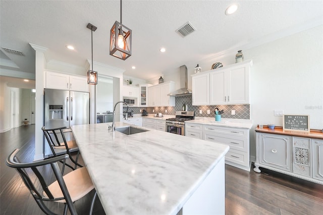 kitchen featuring white cabinetry, sink, wall chimney exhaust hood, and stainless steel appliances