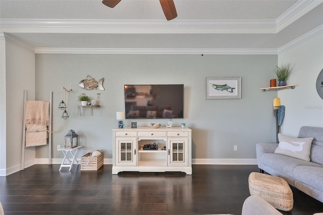 living room with ceiling fan, dark wood-type flooring, and ornamental molding