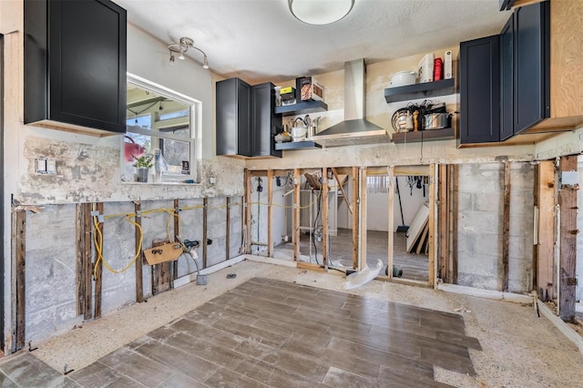 kitchen featuring wall chimney range hood