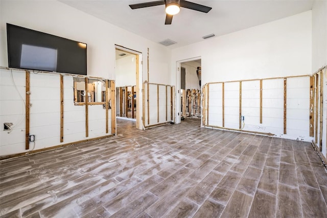 unfurnished living room featuring hardwood / wood-style flooring and ceiling fan