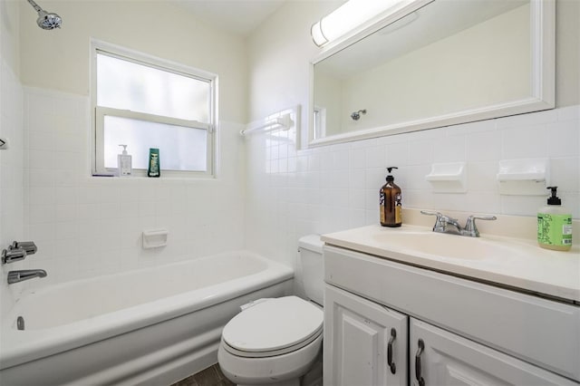 full bathroom with shower / tub combination, vanity, toilet, and tile walls