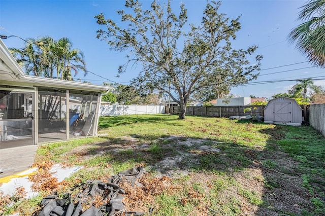 view of yard with a sunroom and a shed