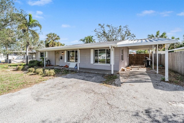 single story home with a porch and a carport