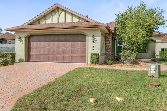 view of front of property with a front yard and a garage