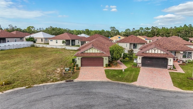 view of front of house with a garage and a front yard