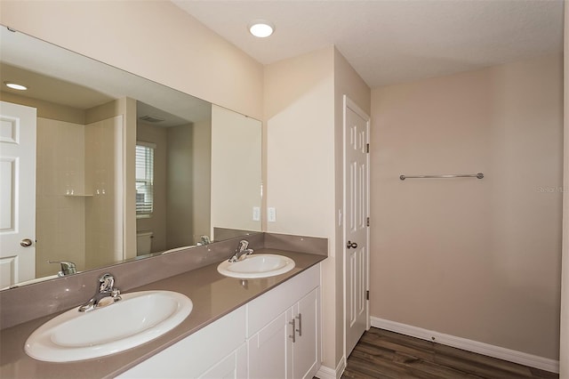 bathroom featuring hardwood / wood-style floors, vanity, and toilet