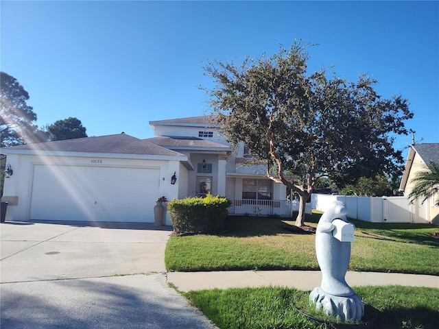 view of front of house with a garage and a front lawn