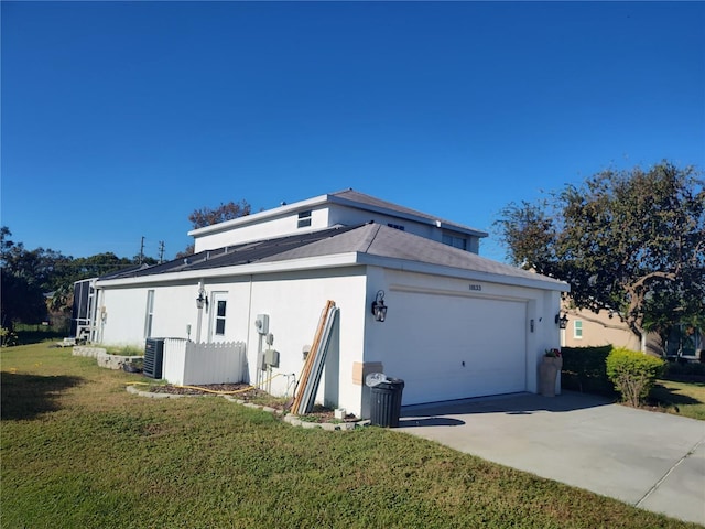 view of side of home with a yard and a garage