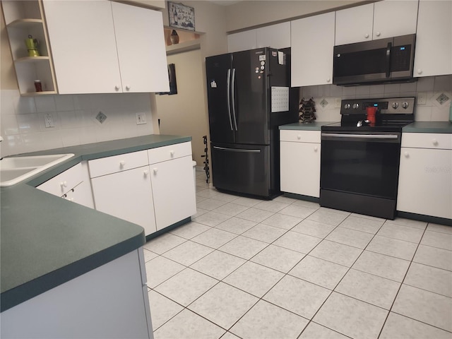 kitchen featuring backsplash, white cabinetry, sink, and appliances with stainless steel finishes