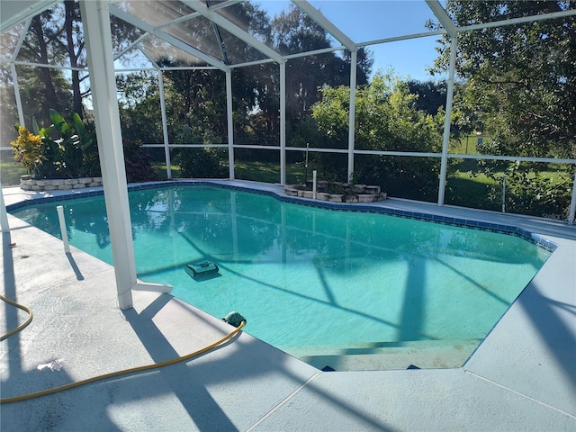 view of pool with glass enclosure