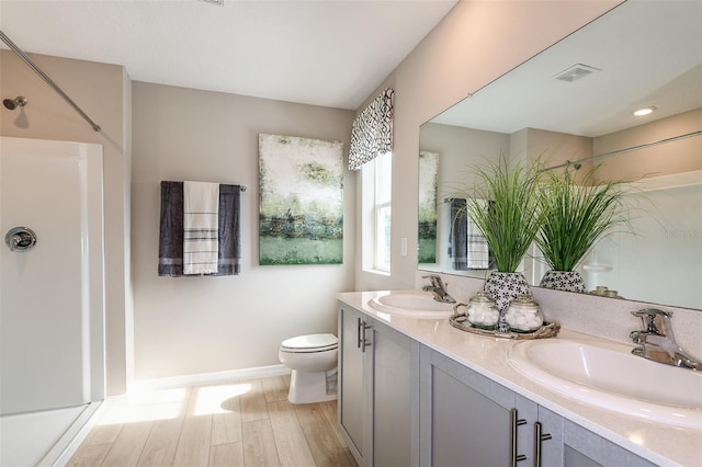 bathroom with vanity, toilet, and wood-type flooring