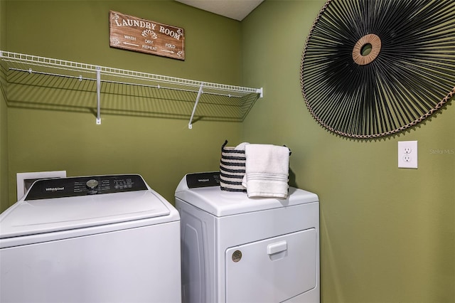 clothes washing area featuring washer and dryer