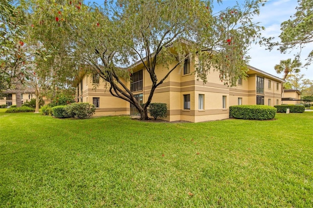 rear view of property featuring a yard