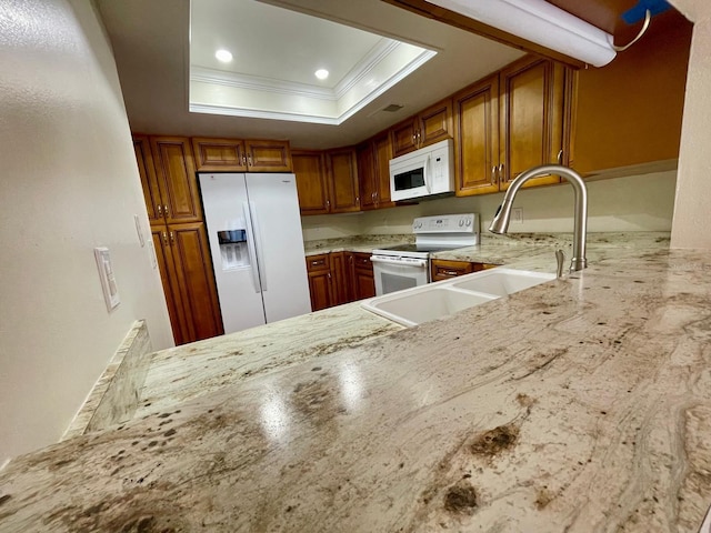 kitchen with white appliances, a raised ceiling, sink, crown molding, and light stone counters