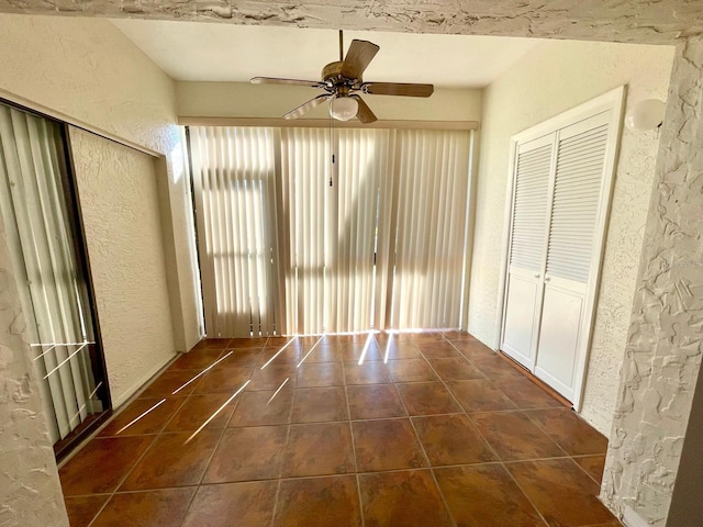 interior space with ceiling fan